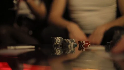 Selective focus on poker chips laying on the table, blurred image of playing Stock Footage 104888662