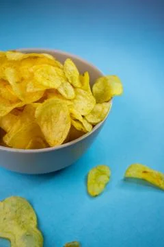 Selective focus, potato chips on a colored background Stock Photos