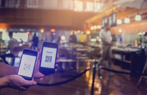 Selective focus to Qr code payment on smart phone in hand with blurry smart p Stock Photos