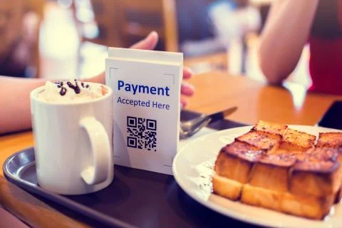 Selective focus to QR code payment tag with blur bread set meal and coffee in Stock Photos