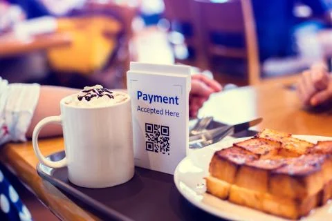 Selective focus to QR code payment tag with blur bread set meal and coffee in Stock Photos