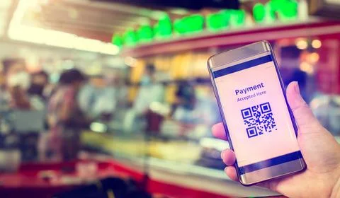Selective focus to QR Code tag on smart phone in hand of customer with blurry Stock Photos