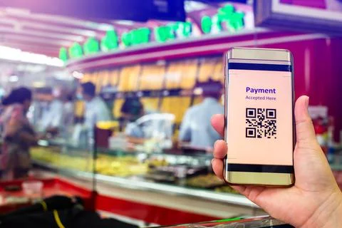 Selective focus to QR Code tag on smart phone in hand of customer with blurry Stock Photos