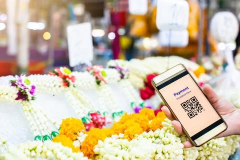 Selective focus to QR Code tag on smart phone in hand of customer with blurry Stock Photos