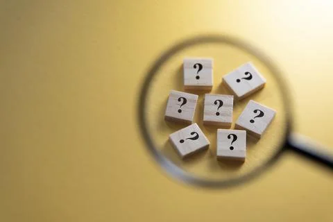 Selective focus on Question Mark symbol using magnifying glass. Stock Photos