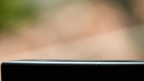 Selective focus of rain drops falling on a metal wall Stock Footage 144089785