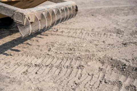 Selective focus on a raised root rake attachment on a skid steer construction Stock Photos