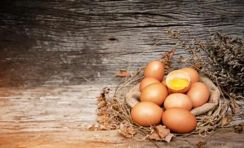 In selective focus of raw eggs on hemp cloth,plenty of dried leaf around,Crus Stock Photos