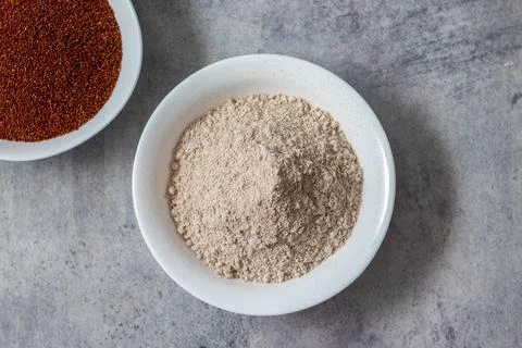 Selective focus of raw "Ragi" with powder. Stock Photos