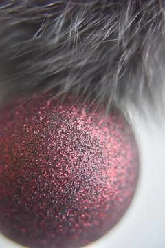 Selective focus at the red ball with glitters on the surface with the fur Stock Photos