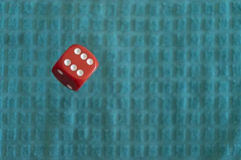 Selective focus of red dice on a blue fabric patterned surface Fotos de archivo