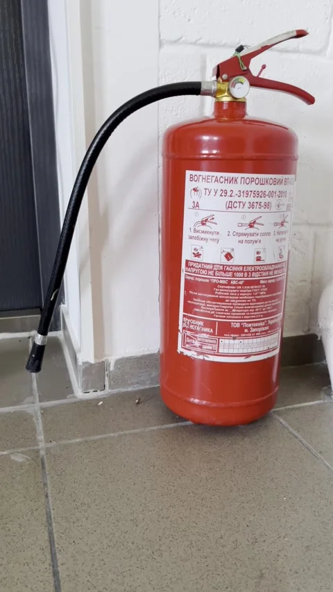 Selective focus on red fire extinguisher ready for emergency use inside bui.. Stock Footage 313714226
