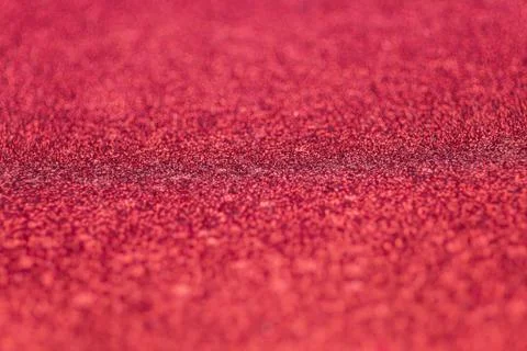 Selective focus on red glitter paper textured with a thin depth of field Stock-Fotos