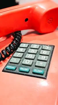 Selective focus. A red old-fashioned telephone Stock Photos