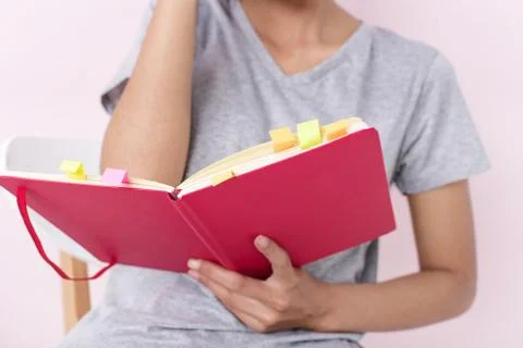 In selective focus of the red opened book in lady hand,blurry light design ba Stock Photos