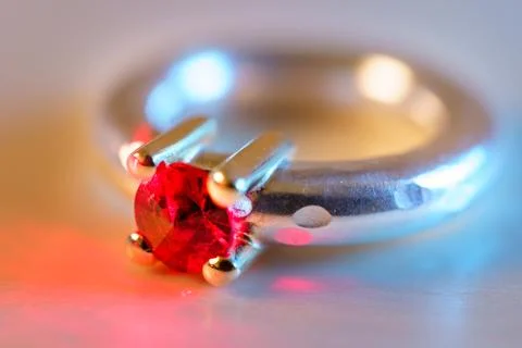 Selective focus of red ruby diamond ring Isolated on wooden background 스톡 사진