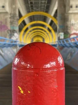 Selective focus on a red traffic pole, futuristic tunnel structure seen on ba Stock Photos