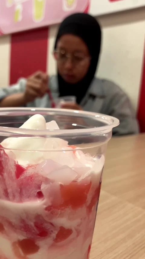Selective Focus On A Refreshing Fruit Dessert Cup With A blurred Woman 스톡 동영상 345705958