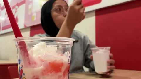 Selective Focus On A Refreshing Fruit Dessert Cup With A blurred Woman Video stock 345705994