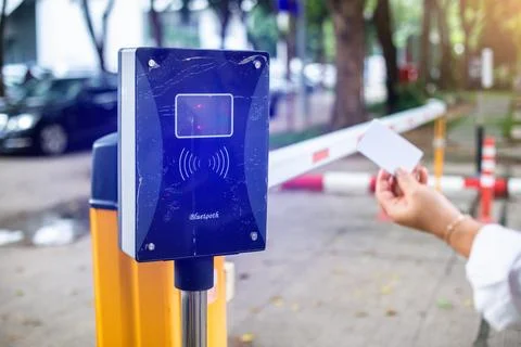 Selective focus to RFID card in hand of driver with blurry RFID reader for .. Stock-Fotos
