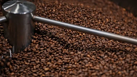 Selective focus of roasted coffee beans in an industrial cooling tray. Stock Footage 327395164