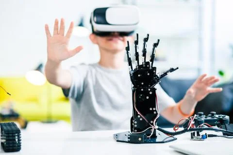 Selective focus of robotic humanoid hand on the table Stock Photos