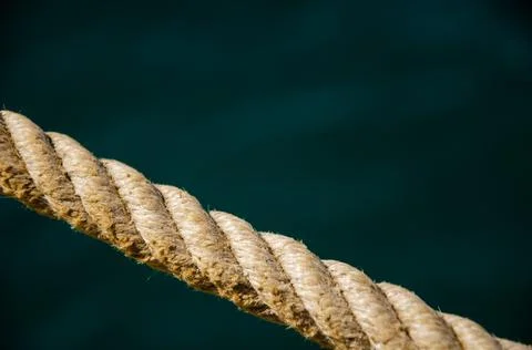 Selective focus on rope texture on blurred sea surface background. Stock Photos