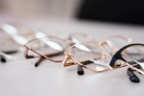 Selective focus row of eyeglasses frames with blurred background Stock Photos