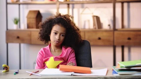 Selective focus of sad african american child doing homework Stock Footage