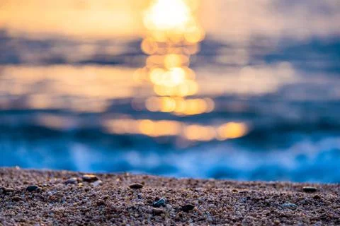 Selective focus on the sand on the beach during sunset Stock Photos