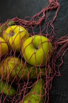 Selective focus, seasonal fruit in a string bag Stock Photos