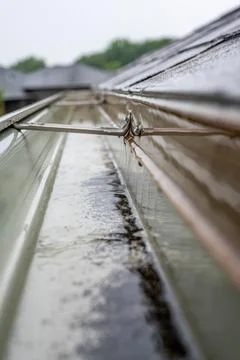 Selective focus on a section of residential guttering with hanger conveying Stock Photos