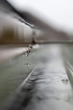 Selective focus on a section of residential guttering with hanger conveying Stock Photos