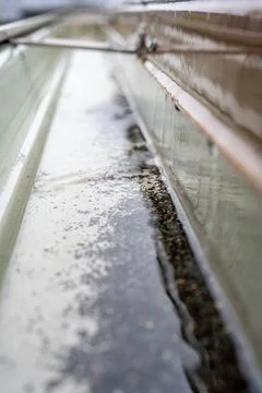 Selective focus on a section of residential guttering with hanger conveying Stock Photos