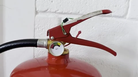 Selective focus on security seal on fire extinguisher valve Stock Footage 313714023