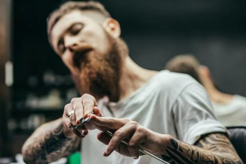 Selective focus of sharp scissors in hands of barber Stock Photos