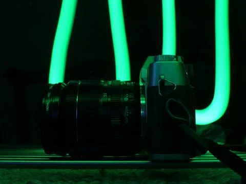 Selective focus shot of a camera against a background of neon elements Stock Photos