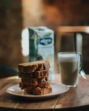 A selective focus shot of delicious bread cake with a glass of chocolate milk Stock Photos