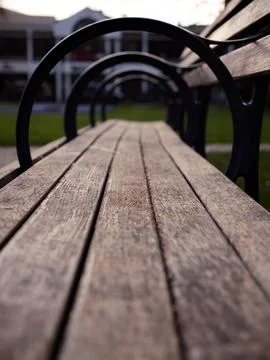 Selective focus shot of an empty bench in a garden Stock-Fotos