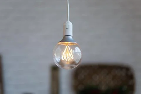 Selective focus shot of a lighted light bulb Stock Photos