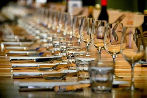 Selective focus shot of long row restaurant table setting perspective view Foto stock
