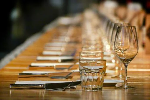 Selective focus shot of long row restaurant table setting perspective view Foto stock
