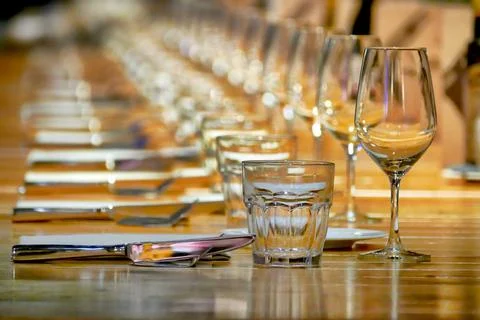 Selective focus shot of long row restaurant table setting perspective view Foto stock