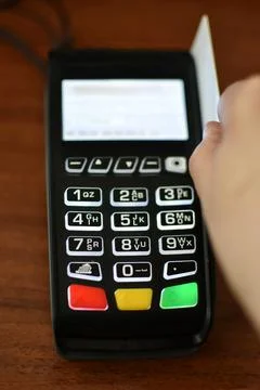 A selective focus shot of a male using a credit card on a POS terminal for pa 写真素材