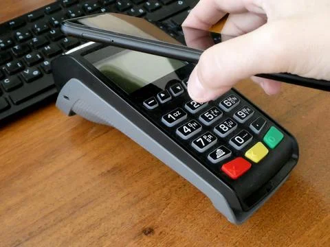 Selective focus shot of a male using a smartphone for contactless payment Stock Photos