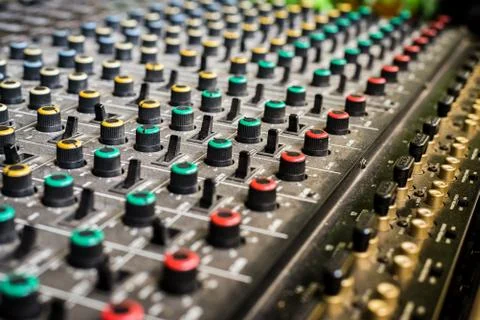 Selective focus shot of a mixer with colored knobs Stock Photos