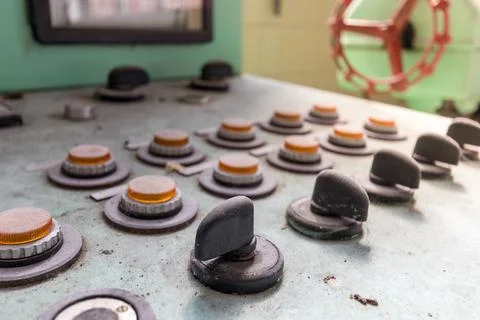 Selective focus shot of an old dusted control panel with manual knobs Fotos de archivo