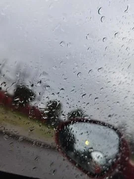 Selective focus shot of rain drops on a car window Stock Photos