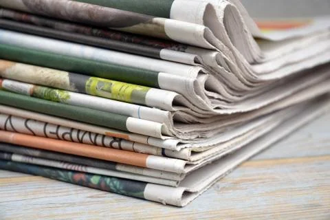 Selective focus shot of the stack of newspapers isolated on a wooden surface 写真素材