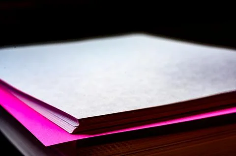 Selective focus on a single colored sheet in a stack of plain white paper Foto stock